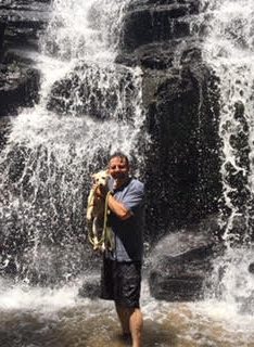 Joseph and his dog at a waterfall